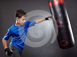 Boy hitting the punching bag