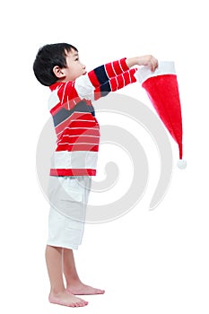 Boy hold santa hat looking upwards