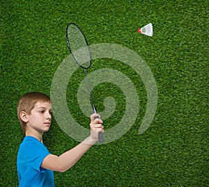 Boy holding badminton racket flying shuttlecock