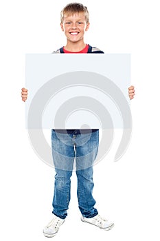 Boy holding blank whiteboard