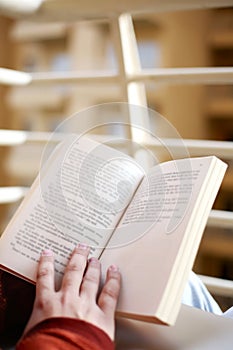 Boy is holding book in hand with reading