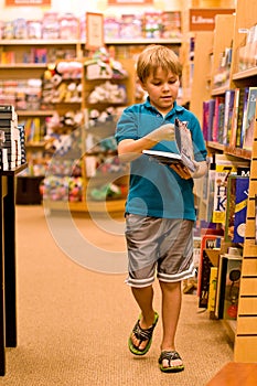 Boy holding book and walking