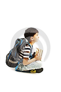 Boy holding books, sitting on floor