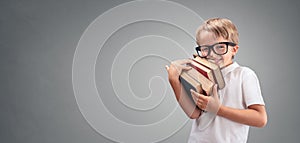 Boy holding and carrying books going back to school background