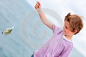 Boy holding caught fish