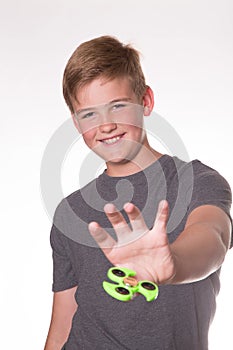 Boy holding fidget spinner photo