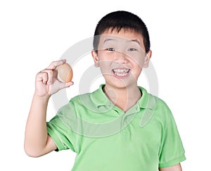Boy holding hen egg in hand on white background isolated