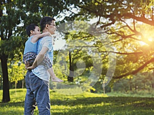 Boy holding his farther`s shoulder with excited on something new