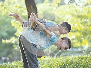 Boy holding his farther`s shoulder with excited on something new