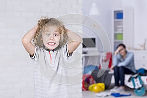 Boy holding his head