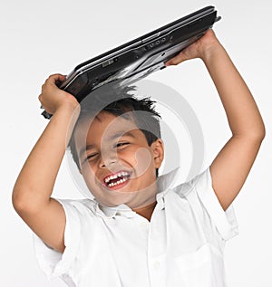 Boy holding laptop on his head