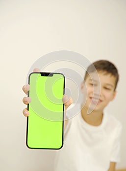 boy holding phone mockup in vertical position. Person using smartphone for showing photo or information. empty screen