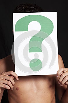 Boy holding a question mark