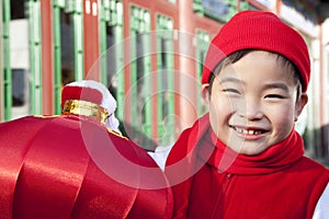 Boy holding red lantern in Courtyard