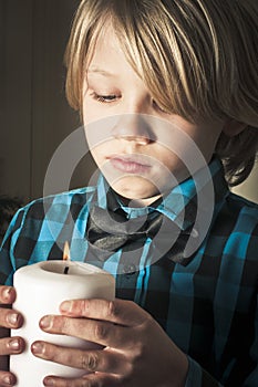 Boy holding a religious candle