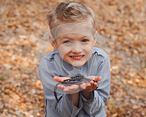 Boy holding salamanders