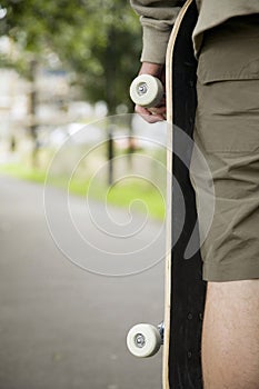 Boy holding skateboard. Conceptual image shot