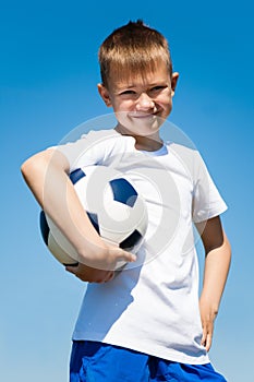 Boy holding a soccer ball.