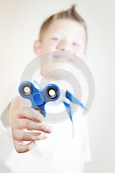 The boy is holding a spinner