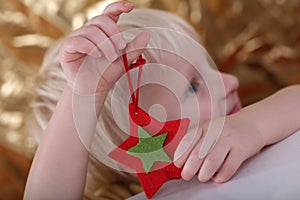 Boy holding star ornament