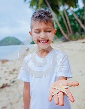 Boy holding a starfish