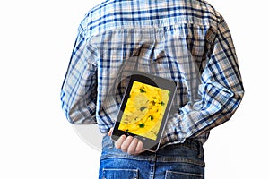 Boy holding tablet computer behind his back