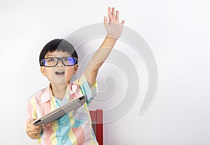 Boy holding tablet raise his hand up