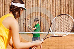 Boy holding tennis ball and racket, starting set