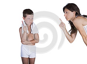 Boy holding toothbrush reprimanded by mother