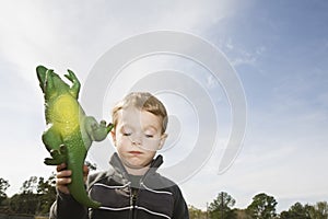 Boy Holding Toy Dinosaur