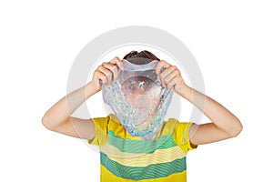 Boy holding a trasparent glitter slime in front of his face. Studio shot, isolated on white