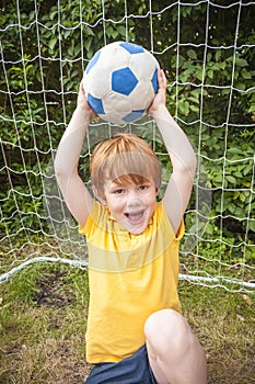 Boy holding up football