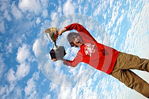 Boy holding up trophy