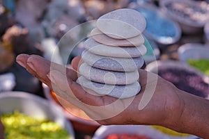 Boy holding white stones pebbles in hand