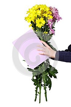 Boy holds a bouquet of yellow and pink chrysanthemums and empty greeting card in his hands. Ð¡oncept holiday greeting.