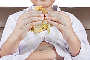 Boy holds a cheeseburger