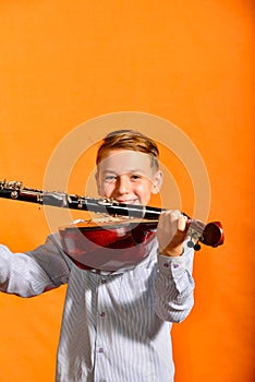 Boy holds dombra and clarinet