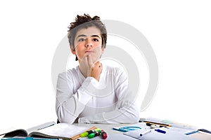 Boy holds his chin meditating on blank book