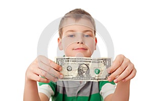 Boy holds one dollar in both hands isolated