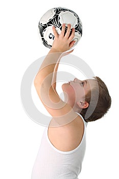 Boy holds soccer ball above head isolated on white