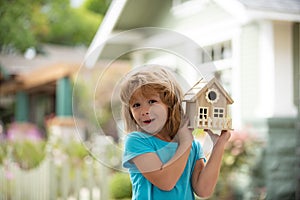 Boy home protection insurance concept, House care in kids hands. Needlework or diy project concept.