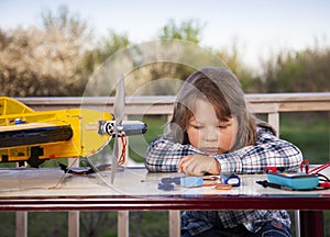 Boy with homemade radio-controlled model aircraft airplane is hand made not copyright