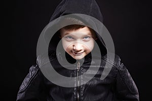 Boy in hood. smiling kid in leather coat and hoodie