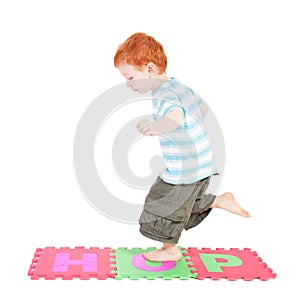 Boy hopping over word