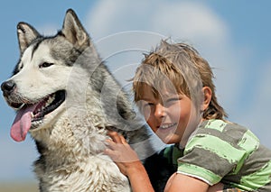 Boy hugging a fluffy dog