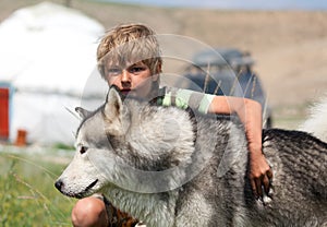 Boy hugging a fluffy dog