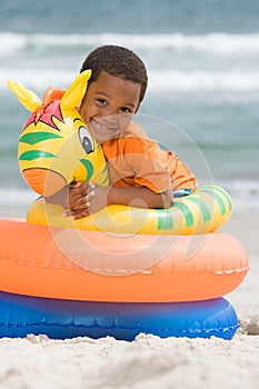 Boy hugging inflatable ring