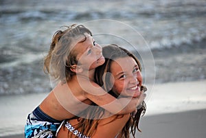 Boy hugging sister while on her back