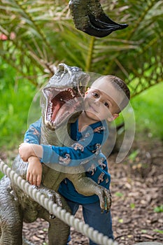 Boy hugging small raptor figure