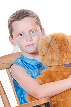 Boy hugging stuffed bear